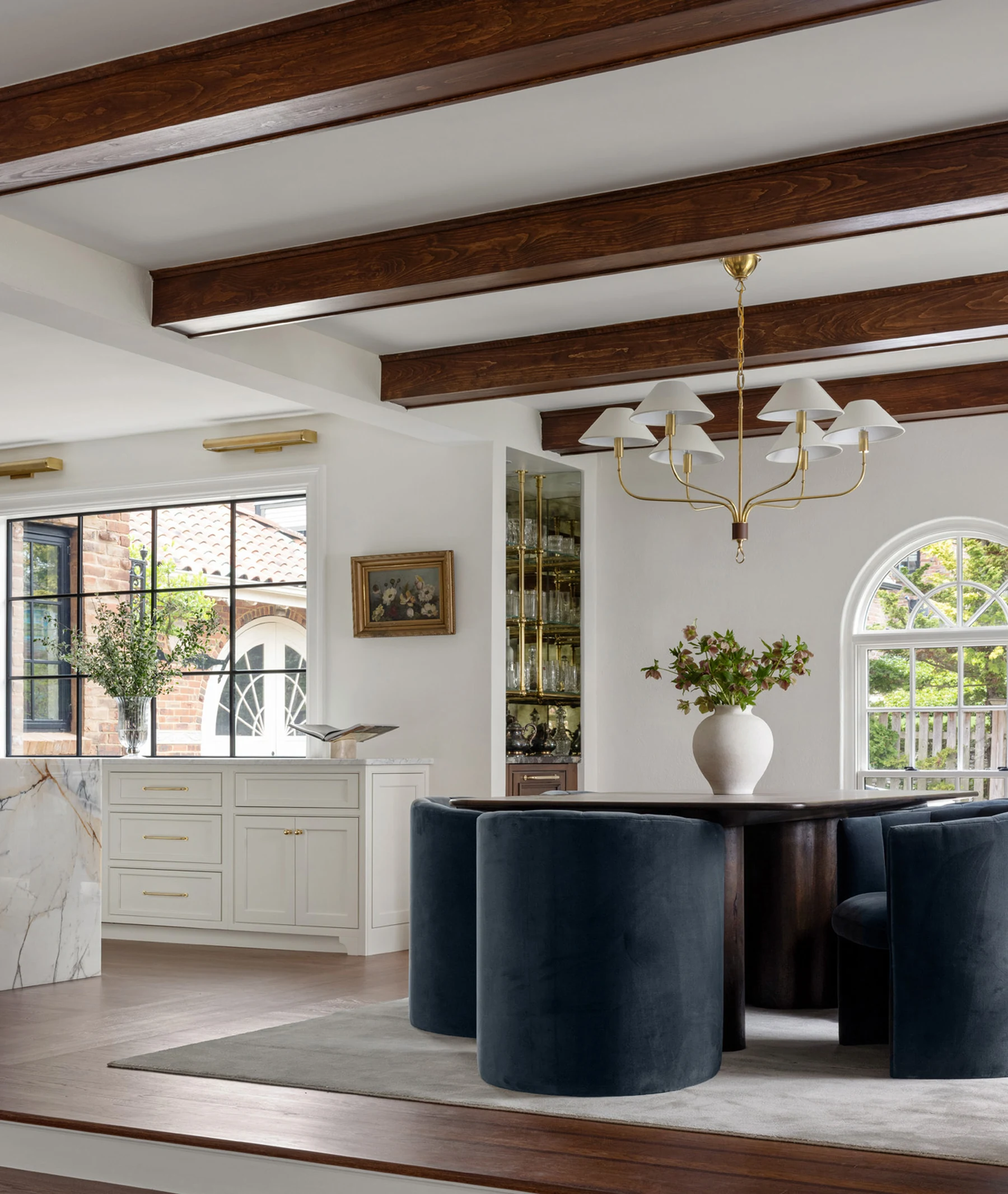 Dining room with navy velvet chairs and wood-beamed ceiling at Project Five Fourteen in Providence, Rhode Island