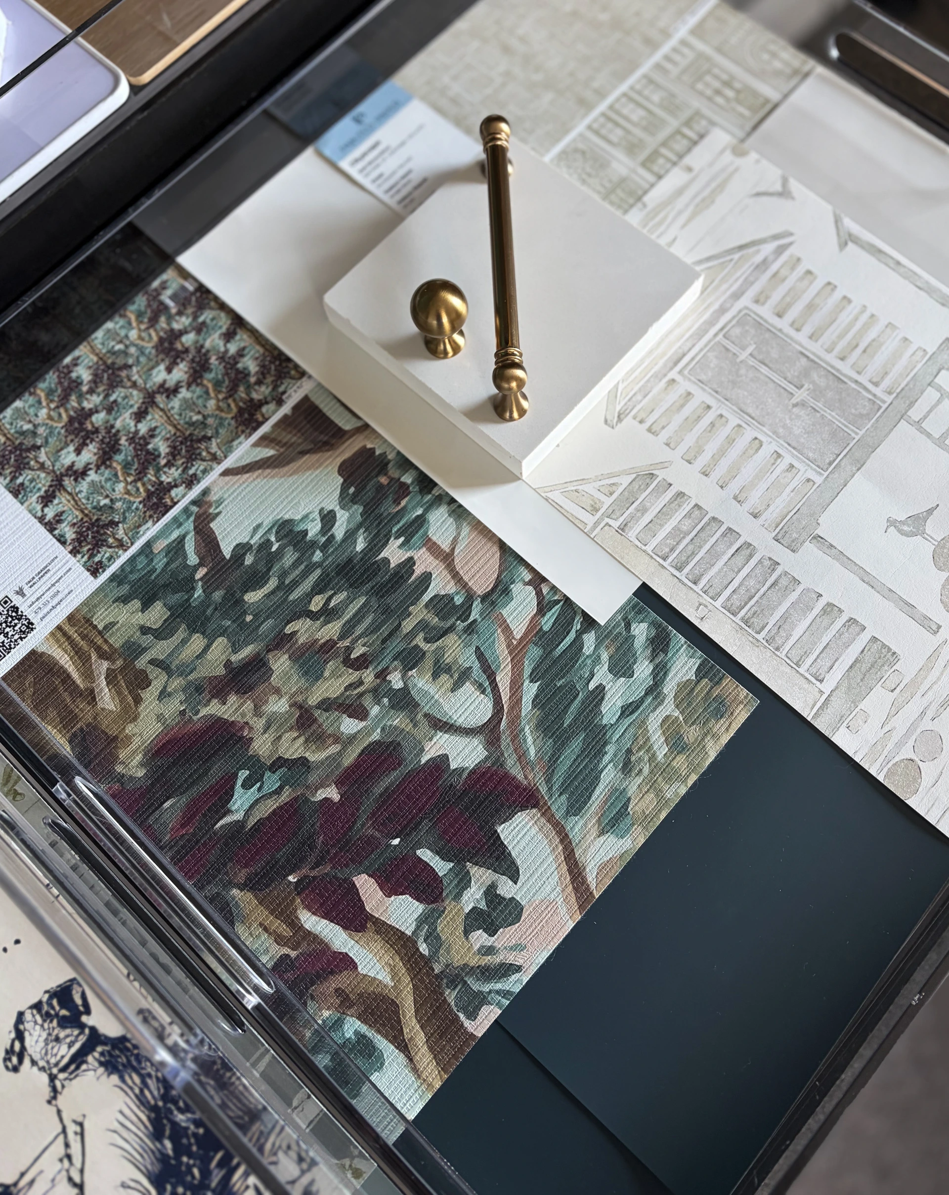 Hill & Harbor design process material selections mood board with fabric samples, brass hardware, stone, and architectural sketch