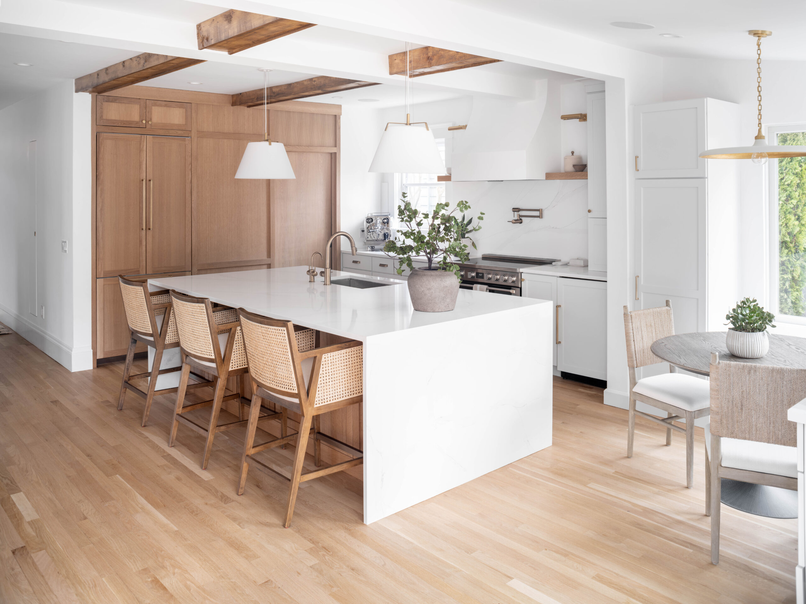 Spacious open-concept kitchen created by removing a structural wall, featuring a large island that serves as the family hub.