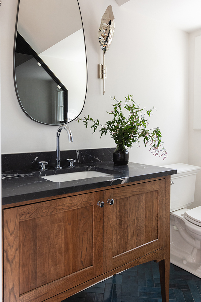 Guest bathroom wood vanity black countertop
