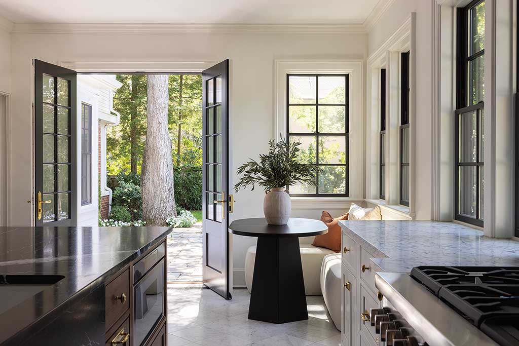 Light-filled breakfast nook opening onto the rear patio through classic French doors.