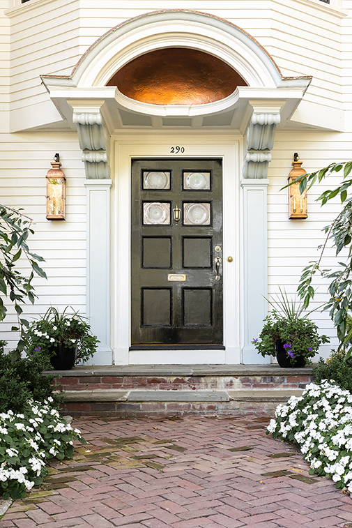 Restored black front door entry portico