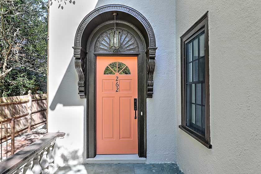 Restored arched front entryway with a salmon-colored door, preserving the curb appeal of this Providence historic home.
