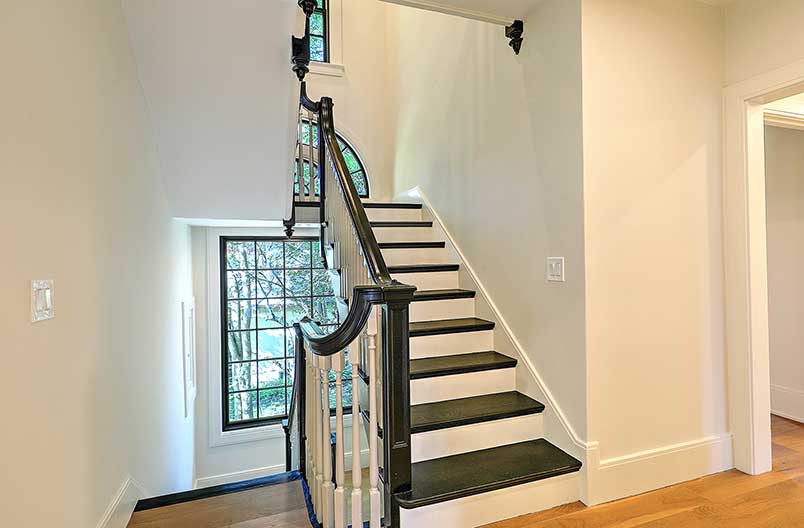 Architectural view of the stairwell connecting the renovated first floor to the new second-story addition.
