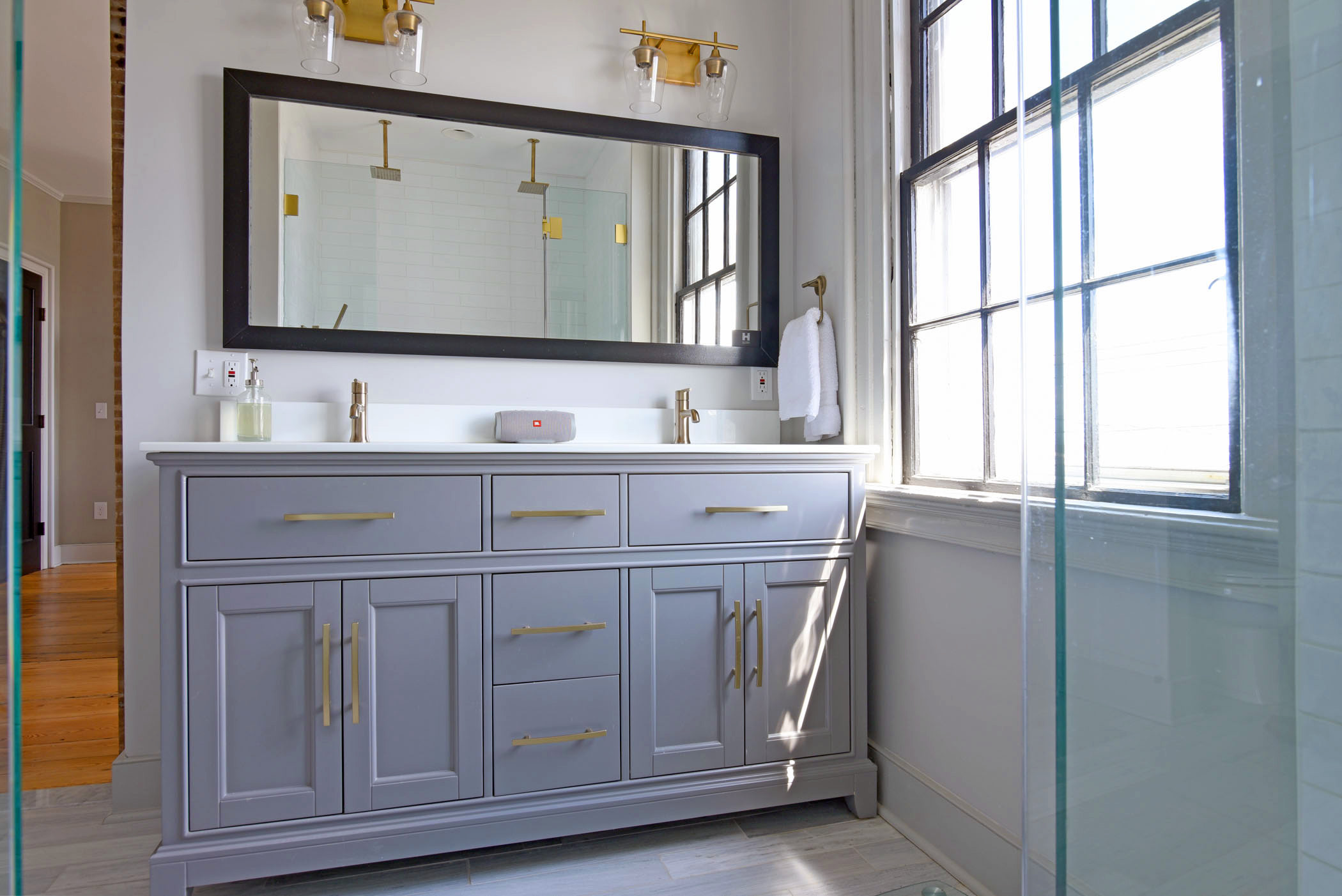 A luxurious en-suite bathroom part of the new primary suite, featuring a double vanity and modern finishes.