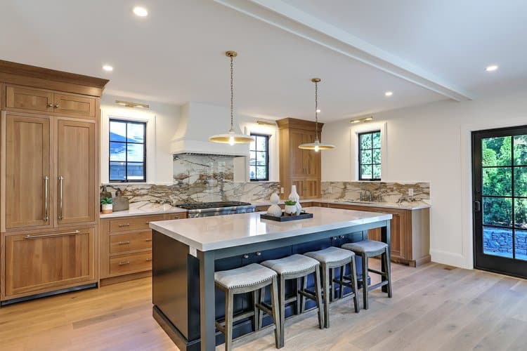 Expansive chef's kitchen featuring natural wood cabinetry and a large central island, part of a Providence home addition.