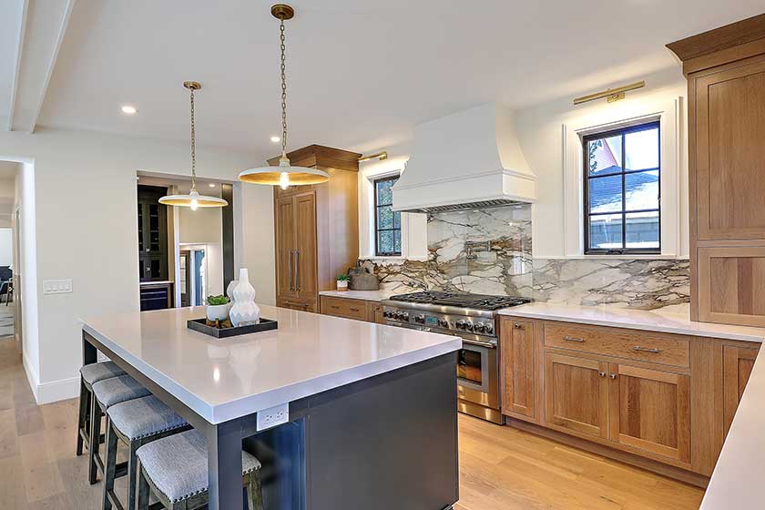 Angled view of the relocated kitchen showing the improved flow and connection to the dining spaces.