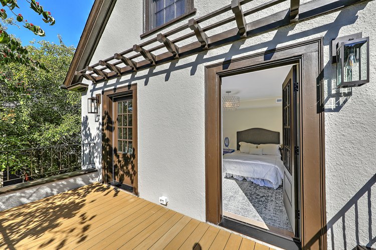 Primary suite access to a private outdoor balcony, blurring indoor and outdoor lines.