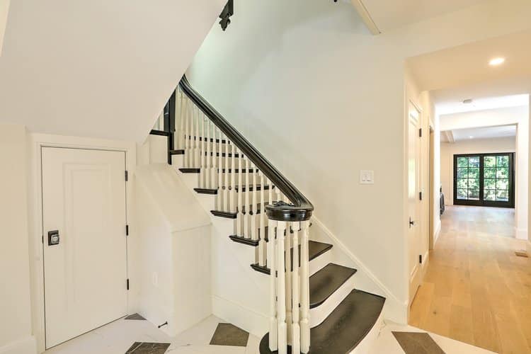 Restored staircase railing and newel post, maintaining the historic integrity of the interior.