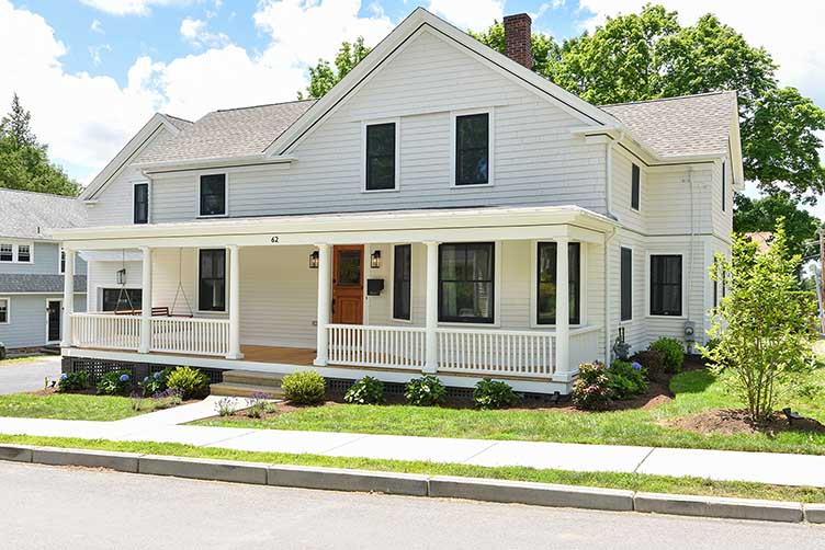 Restored front facade and porch of an 1870 East Greenwich home, preserving its architectural integrity.