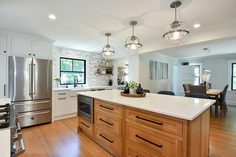 Spacious kitchen design with a custom wood island and stainless steel appliances, improving flow for family life.
